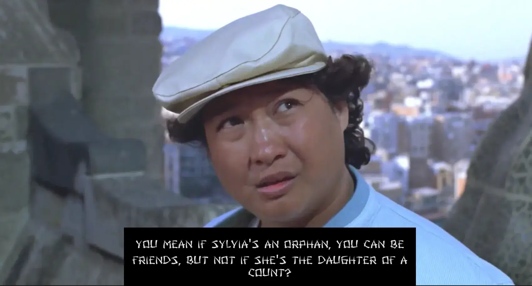Sammo Hung atop a terrace when Sylvia is told by her father's butler that she was a count's daughter. This is also the moment when David and Thomas want to walk away from her Sylvia. In this picture, the camera is focused on Sammo Hung and sunshine is shining down on him. He's looking at Thomas and David with glistening eyes and asking them: 