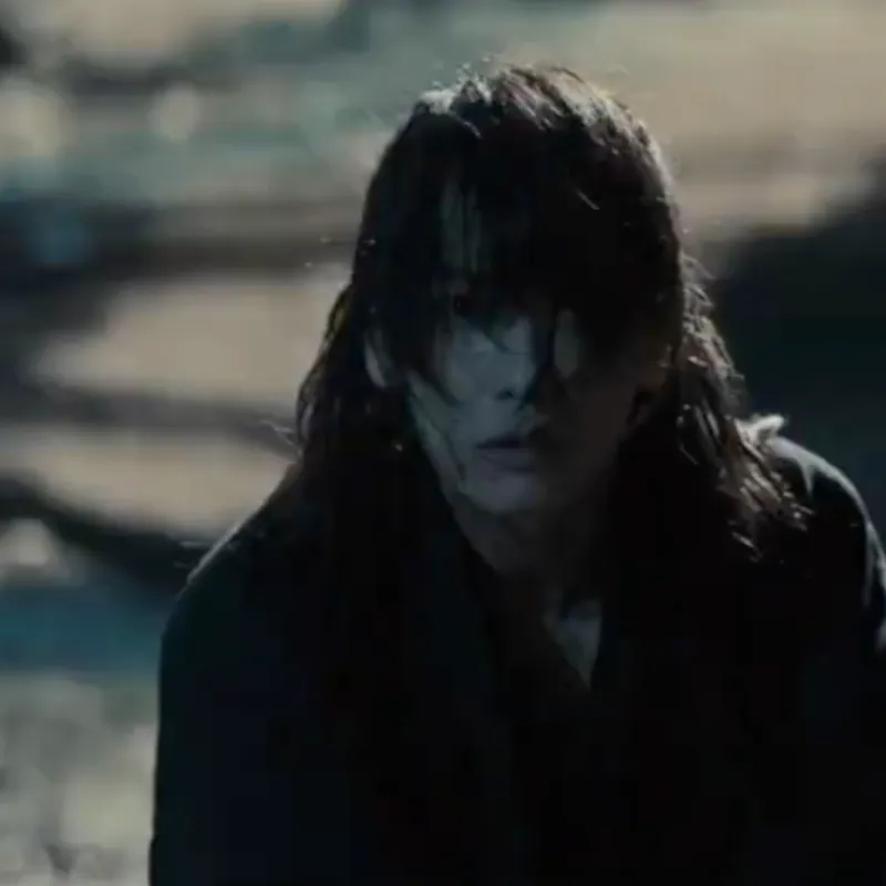 Image of Kenshin kneeling after splattering his adversary's blood on Lady Tomoe by accident. Kenshin has a frightened look on his face.